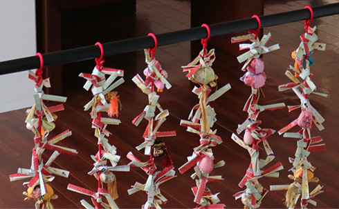 In Japan, the slip of paper with good fortune is tied to the branch of a tree at a shrine/temple ground or taken with you. The slip of paper with bad fortune is tied to the branch with the non-dominant hand.